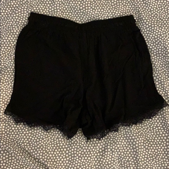 Black fabric shorts with lace detail on bottom - Picture 2 of 3